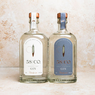 GIN MARTINI BUNDLE Two bottles of 58 AND CO. Gin on a textured surface - LONDON DRY GIN AND NAVY STRENGTH GIN