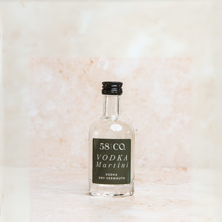 Bottle of 58 AND CO mini Vodka Martini on a light marble background