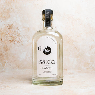 Bottle of 58 and CO British Shōchū - TORI 2023 (2 x 70cl) on a textured beige background