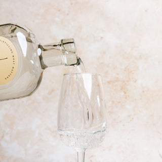 58 and co triple distilled vodka bottle and glass on a light marble surface