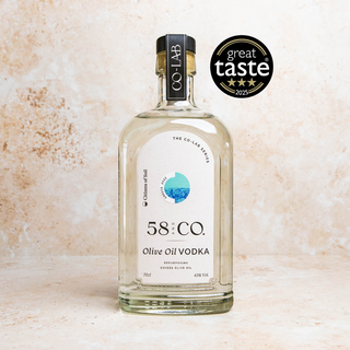 Bottle of 58 and CO Olive Oil Vodka Greece with a 'Great Taste' award on a textured beige background