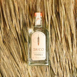 Bottle of 58 and CO Vodka on a bed of wheat background
