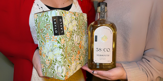 Bottle of 58 and CO British Bianco Vermouth and Box of Laylo Pinot grigio wine being held up together