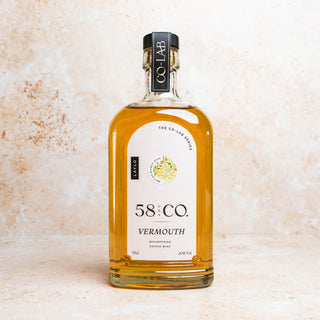 Bottle of 58:CO Vermouth on a textured beige background