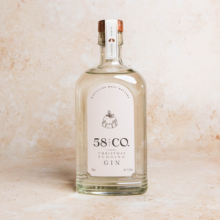 Bottle of 58 and CO Christmas Pudding Gin on a beige background