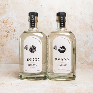 Two bottles of 58 and CO. Shochu on a textured surface
