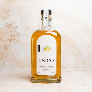 Bottle of 58 and Co British Bianco Vermouth on a textured beige background