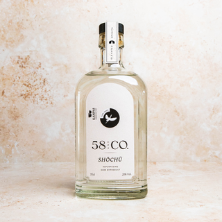 Bottle of 58 & Co Tori Shochu on a textured beige background