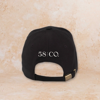 Black cap with '58 & CO' logo on a beige background