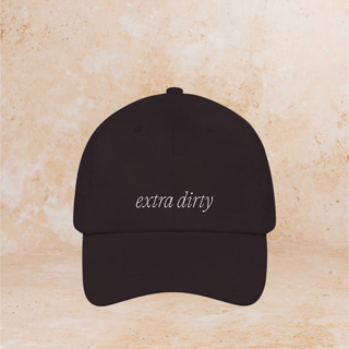 Black cap with 'extra dirty' text on a beige background