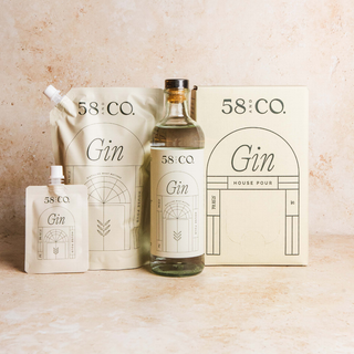 Collection of 58 and CO House Pour Gin products on a beige background - glass bottle, refill pouch, mini travel pouch and refill box