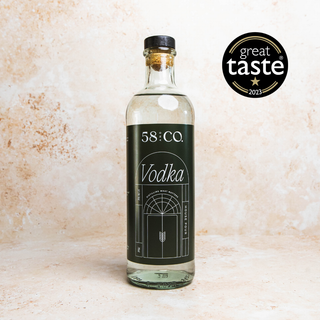 Bottle of 58 and CO. House Pour Vodka with a 'Great Taste' award logo on a textured beige background