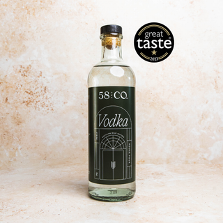 Bottle of 58 and CO. House Pour Vodka with a 'Great Taste' award logo on a textured beige background
