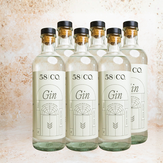 Six bottles of 58 and Co Gin on a textured surface