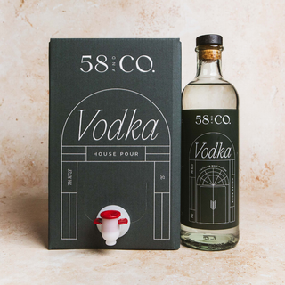 Bottle and box of 58 & Co. Vodka on a beige background