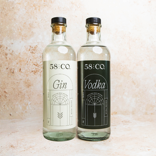 Two bottles of 58 and Co. House Pour Gin and Vodka on a textured surface