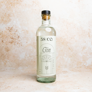 Bottle of 58 and CO House Pour Gin on a textured beige background