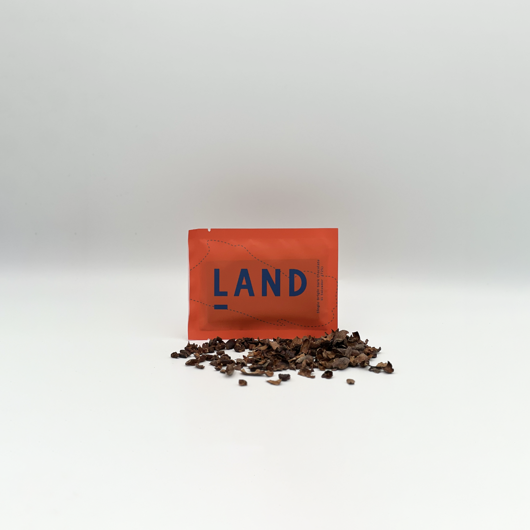 a bar of Land Chocolate and some cacao nibs and husks